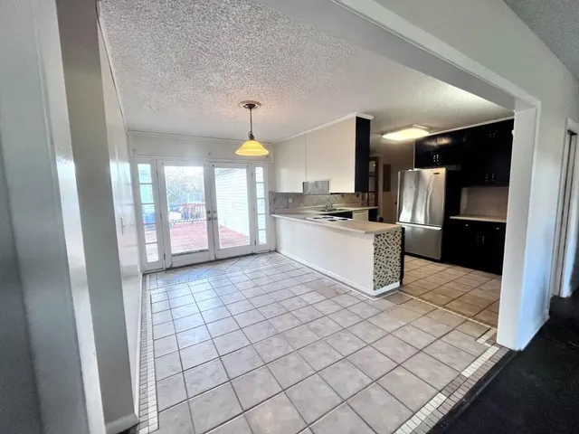 a kitchen with stainless steel appliances a refrigerator and stove