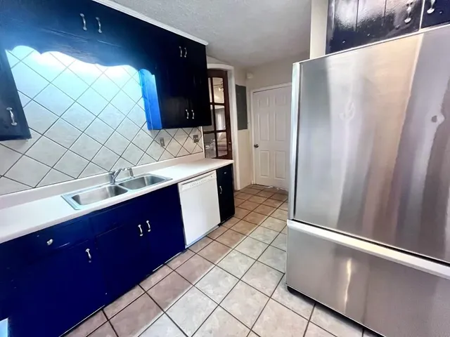 a kitchen with stainless steel appliances a sink stove and refrigerator