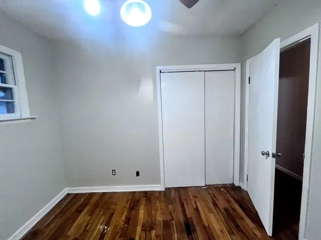a view of a room with wooden floor and closet