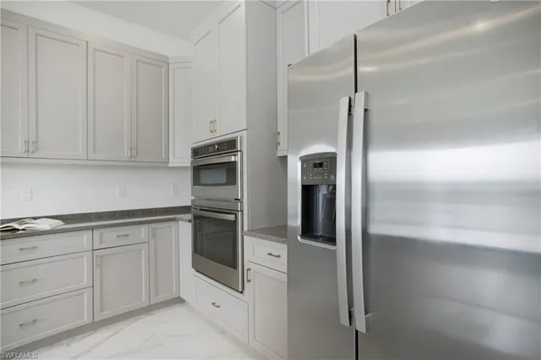 a kitchen with granite countertop a sink and a counter top space