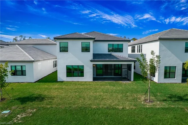 a front view of a house with a garden and yard