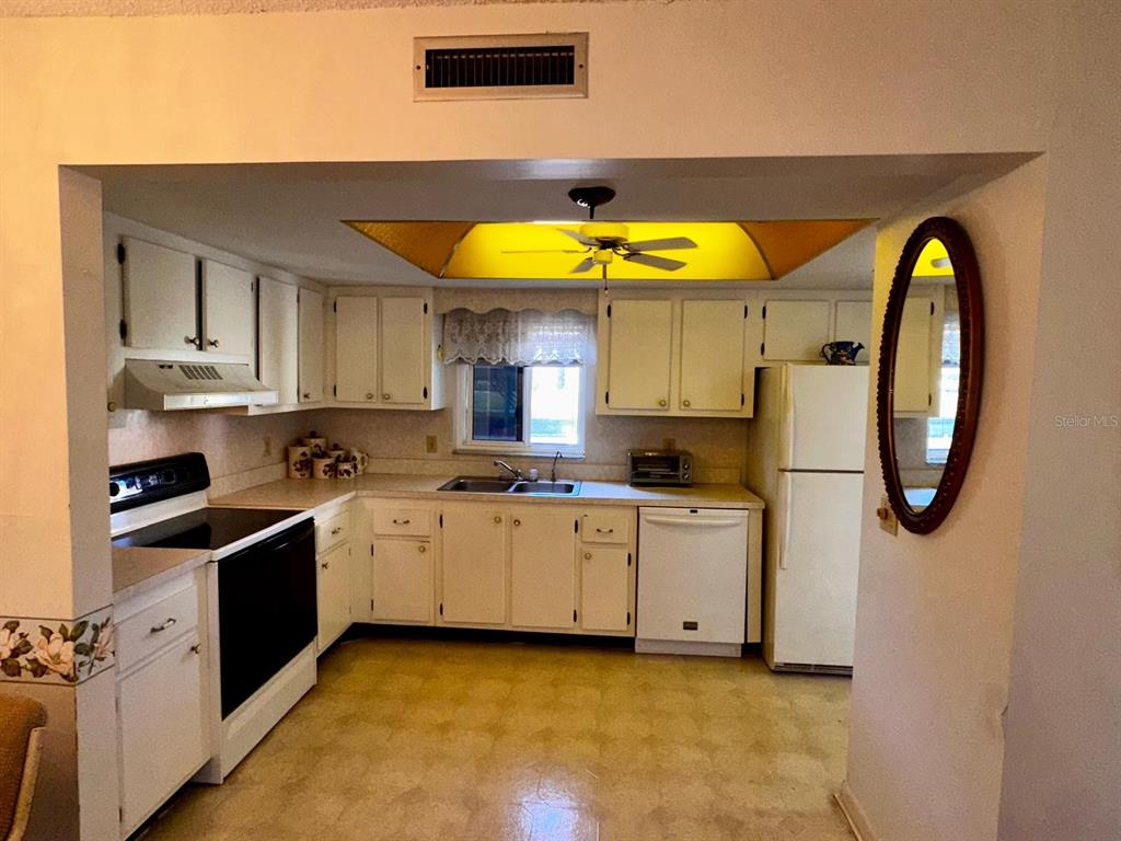 7040 Cognac Drive, Unit 1 New Port Richey, FL 34653 - Photo 11 of 45 a kitchen with a sink a stove and cabinets