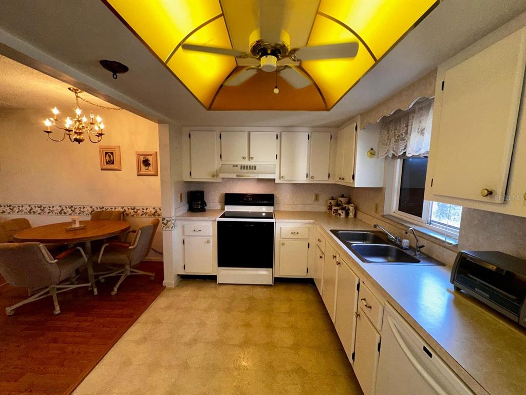 7040 Cognac Drive, Unit 1 New Port Richey, FL 34653 - Photo 12 of 45 a kitchen with a sink appliances and cabinets