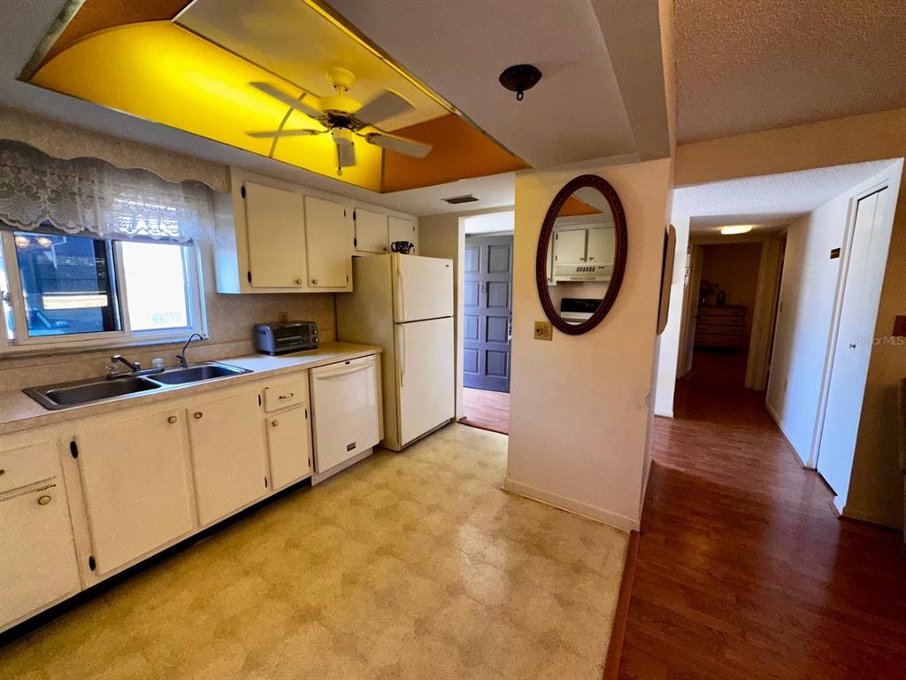 7040 Cognac Drive, Unit 1 New Port Richey, FL 34653 - Photo 13 of 45 a kitchen with cabinets and wooden floor