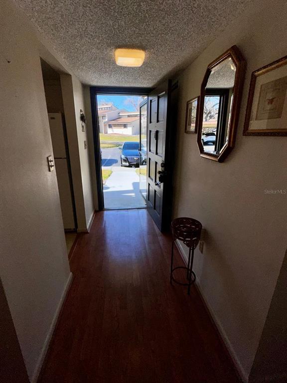 7040 Cognac Drive, Unit 1 New Port Richey, FL 34653 - Photo 15 of 45 wooden floor in a hall with a window