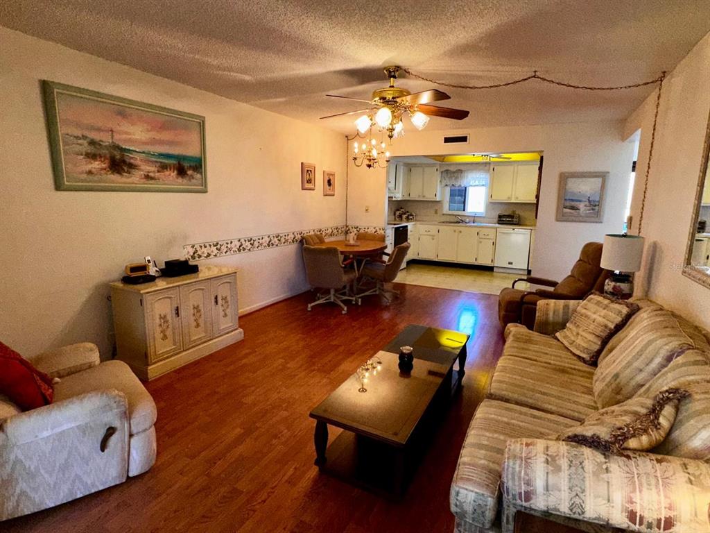 7040 Cognac Drive, Unit 1 New Port Richey, FL 34653 - Photo 17 of 45 a living room with furniture and a chandelier