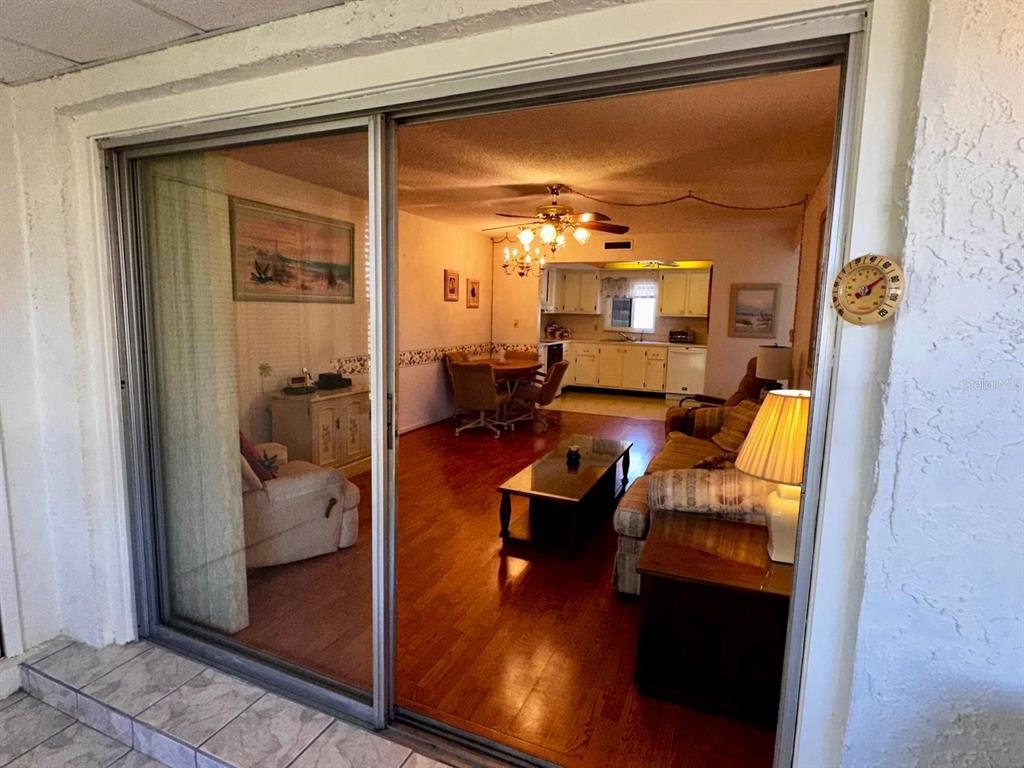 7040 Cognac Drive, Unit 1 New Port Richey, FL 34653 - Photo 18 of 45 a outdoor space with patio the couch and glass door