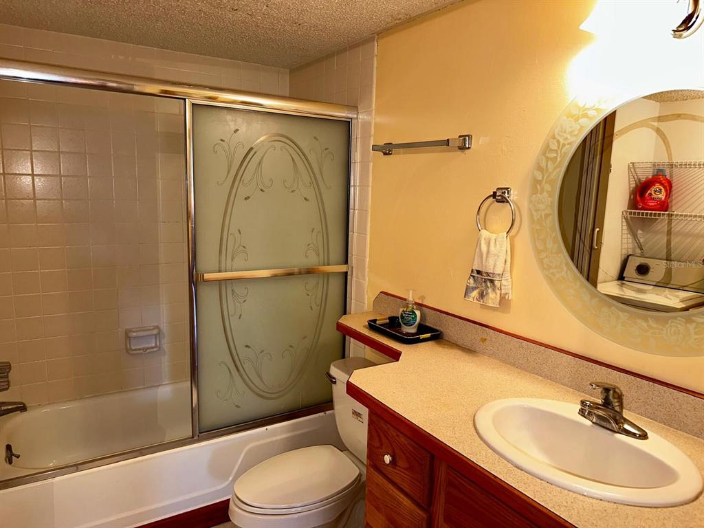 7040 Cognac Drive, Unit 1 New Port Richey, FL 34653 - Photo 20 of 45 a bathroom with a sink toilet and shower