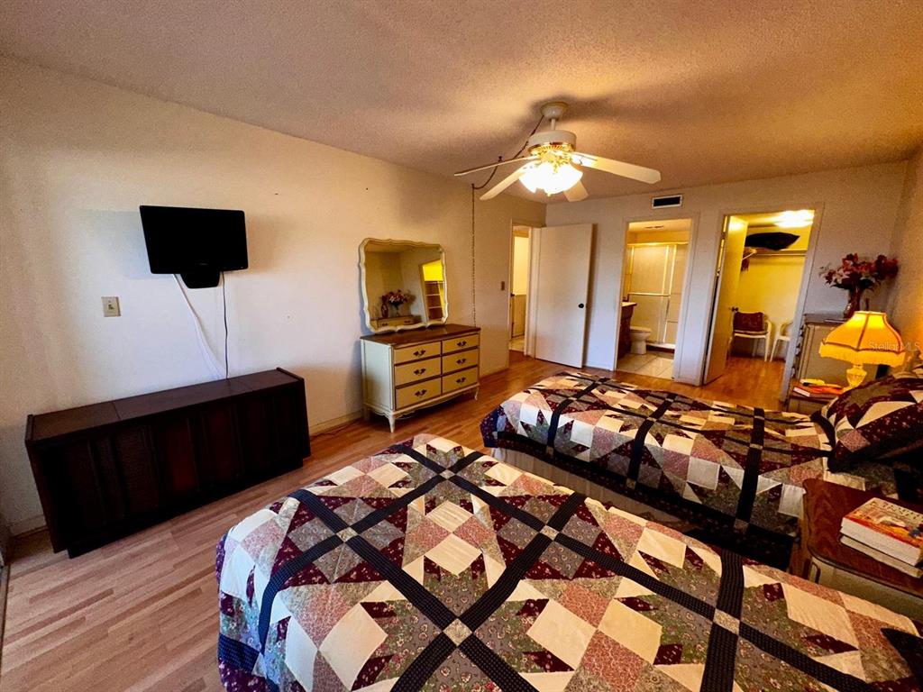 7040 Cognac Drive, Unit 1 New Port Richey, FL 34653 - Photo 23 of 45 a bedroom with a bed and a flat tv screen on dresser