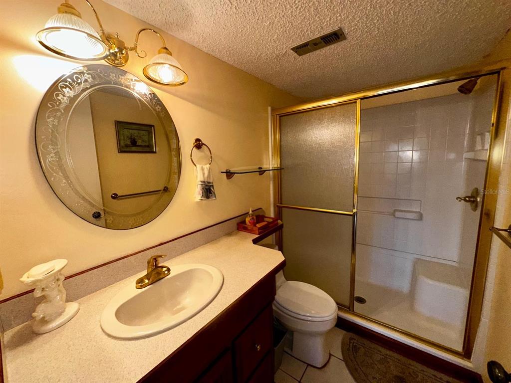 7040 Cognac Drive, Unit 1 New Port Richey, FL 34653 - Photo 27 of 45 a bathroom with a sink vanity mirror and toilet