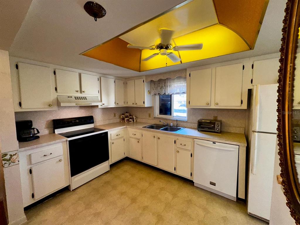 7040 Cognac Drive, Unit 1 New Port Richey, FL 34653 - Photo 6 of 45 a kitchen with cabinets and appliances
