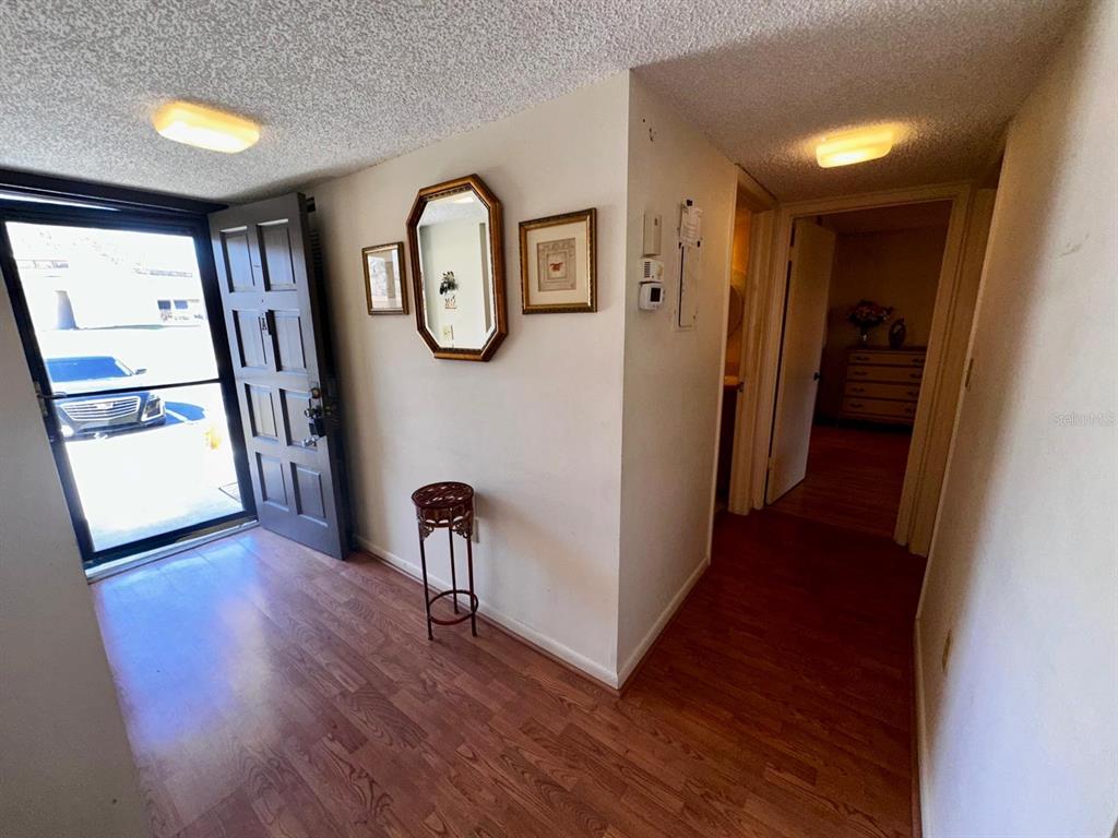 7040 Cognac Drive, Unit 1 New Port Richey, FL 34653 - Photo 9 of 45 a view of a hallway with wooden floor and stairs