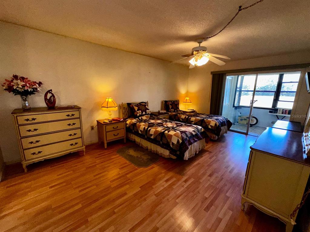 7040 Cognac Drive, Unit 1 New Port Richey, FL 34653 - Photo 10 of 45 a bedroom with furniture and a large window