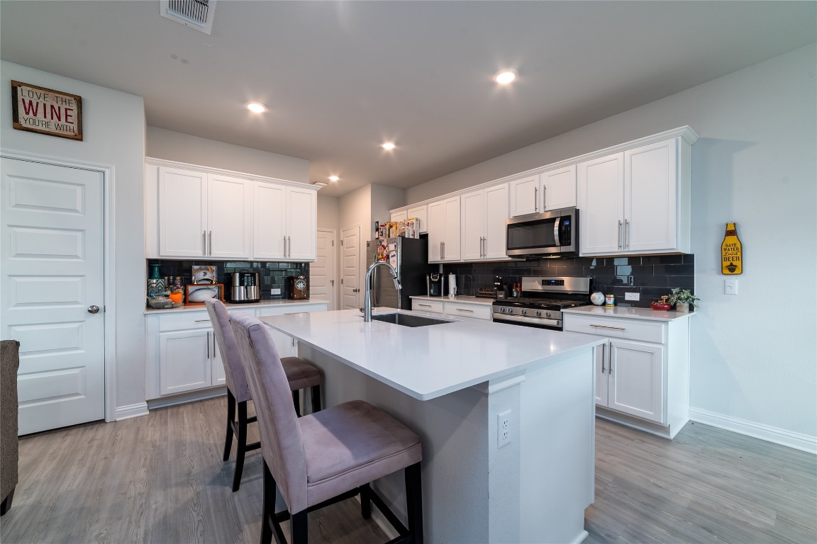 8505 Leroi Drive, Unit 358 Austin, TX 78744 - Photo 12 of 37 a view of kitchen with microwave stove top oven and cabinets