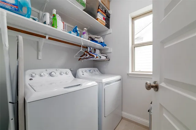 a open kitchen with stainless steel appliances granite countertop a stove top oven a sink dishwasher a dining table and chairs with wooden floor