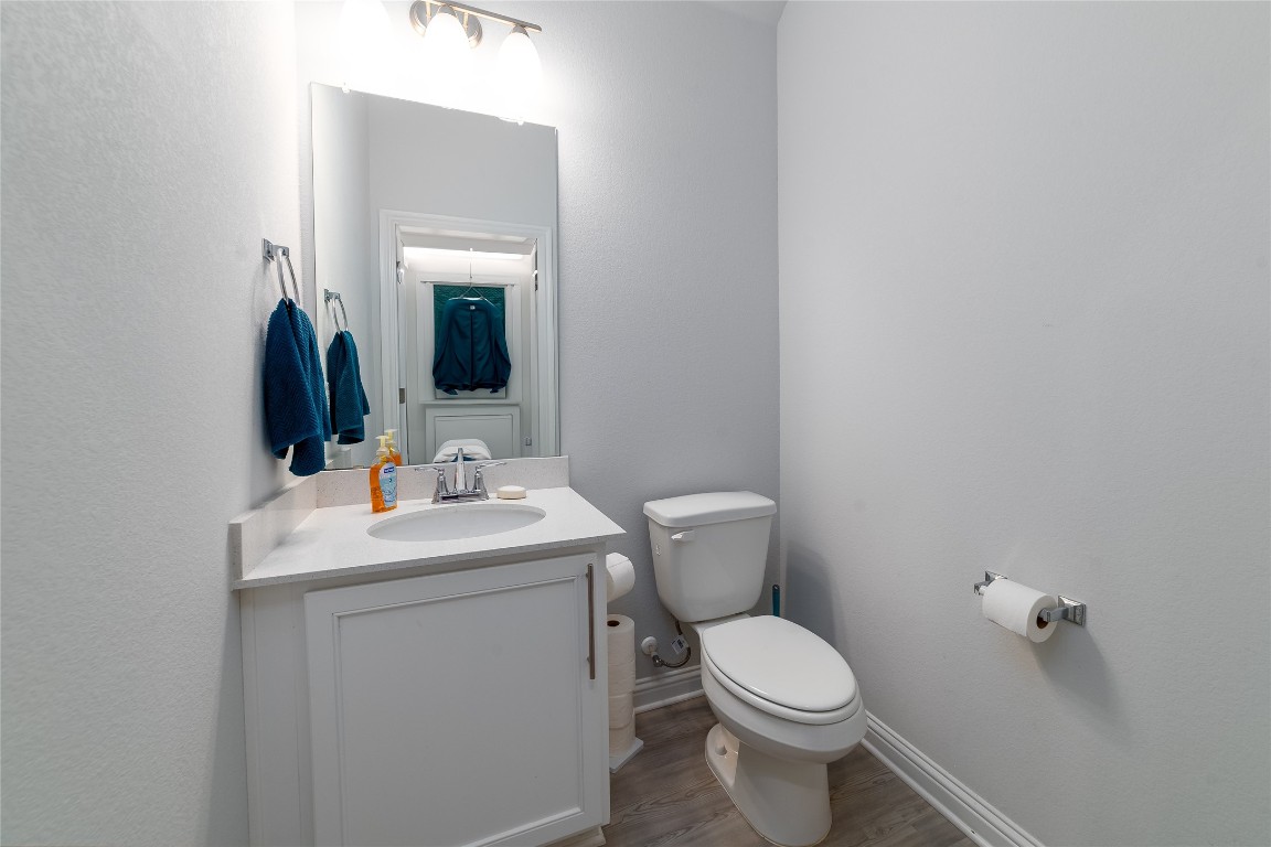 8505 Leroi Drive, Unit 358 Austin, TX 78744 - Photo 20 of 37 a bathroom with a toilet sink and mirror