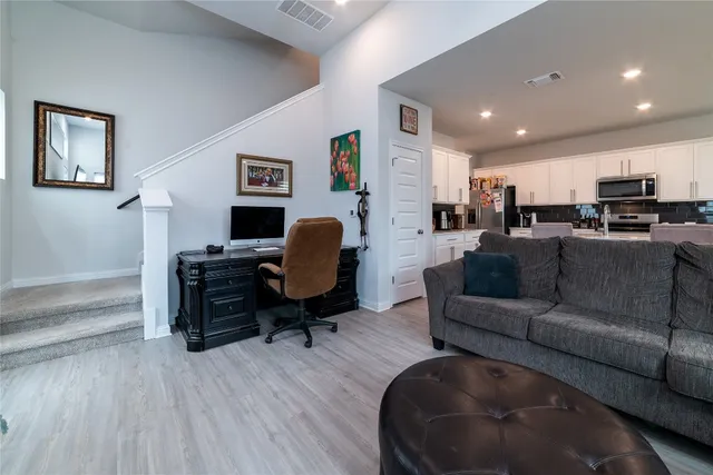a kitchen with microwave a sink and chairs