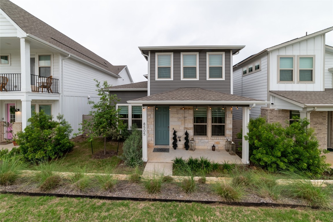 8505 Leroi Drive, Unit 358 Austin, TX 78744 - Photo 3 of 37 a front view of a house with a yard and potted plants