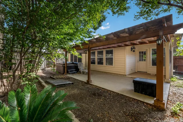 a view of a patio with table and chairs with wooden fence and plants