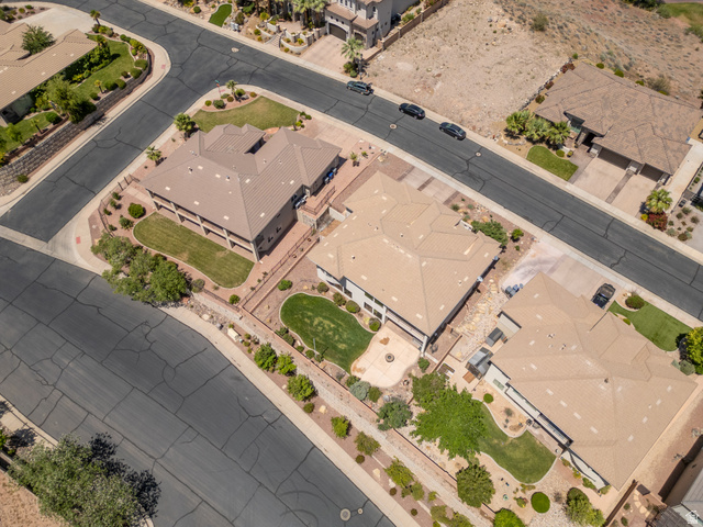 2005 West 450 S Circle St. George, UT 84770 - Photo 50 of 57 Expansive corner lot property featuring a multi-level structure with a patio, green spaces, and mature landscaping