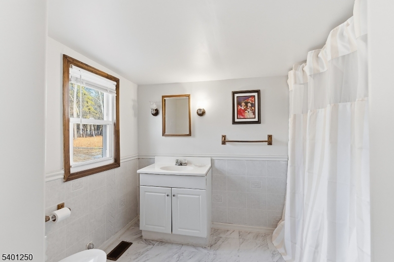 491 Lakehurst Road Browns Mills, NJ 08015 - Photo 11 of 17 a bathroom with a sink a toilet and a window