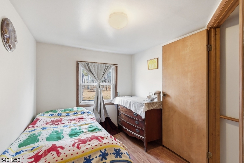 491 Lakehurst Road Browns Mills, NJ 08015 - Photo 13 of 17 a bedroom with a bed and a window