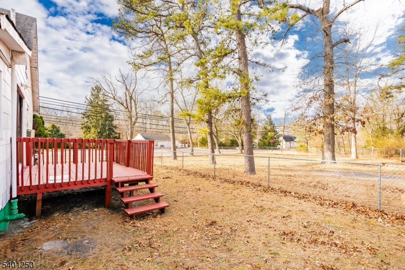 491 Lakehurst Road Browns Mills, NJ 08015 - Photo 15 of 17 a backyard of a house with trees and outdoor space