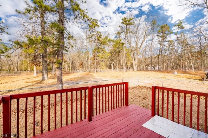 491 Lakehurst Road Browns Mills, NJ 08015 - Photo 16 of 17 a balcony with wooden floor and trees