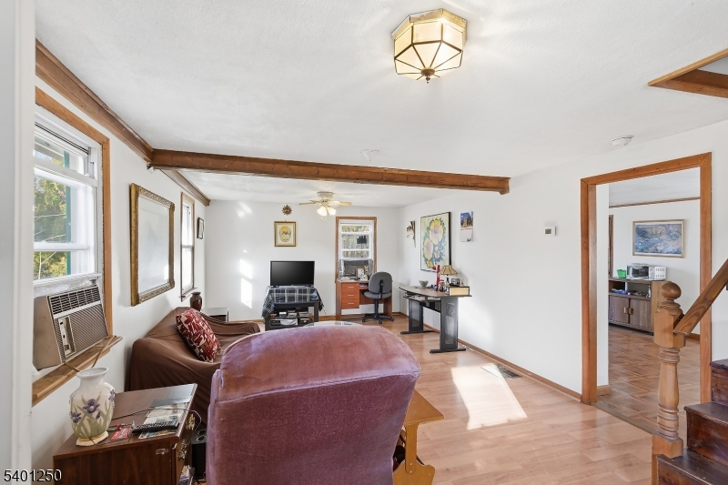 491 Lakehurst Road Browns Mills, NJ 08015 - Photo 6 of 17 a living room with furniture fireplace and a large window