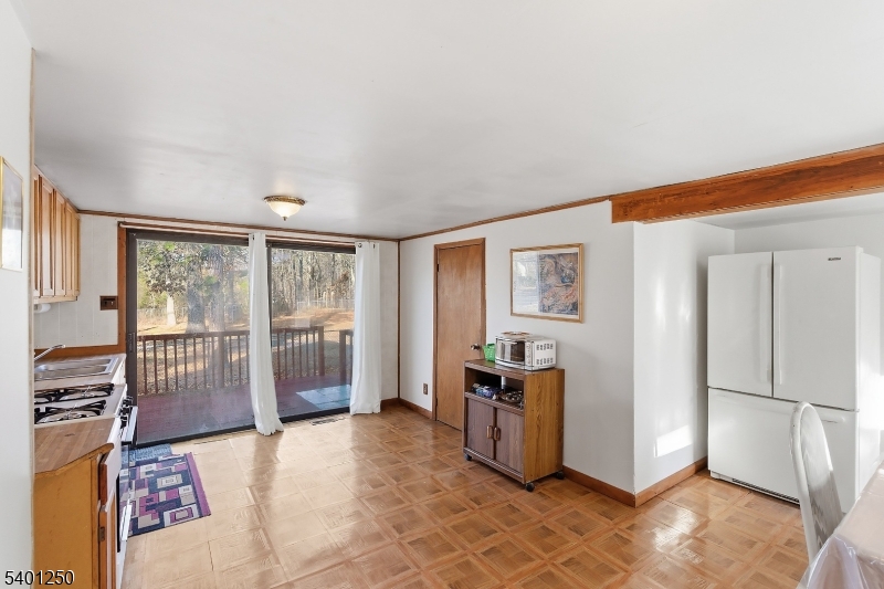 491 Lakehurst Road Browns Mills, NJ 08015 - Photo 7 of 17 a spacious bedroom with a balcony a bed and a large window