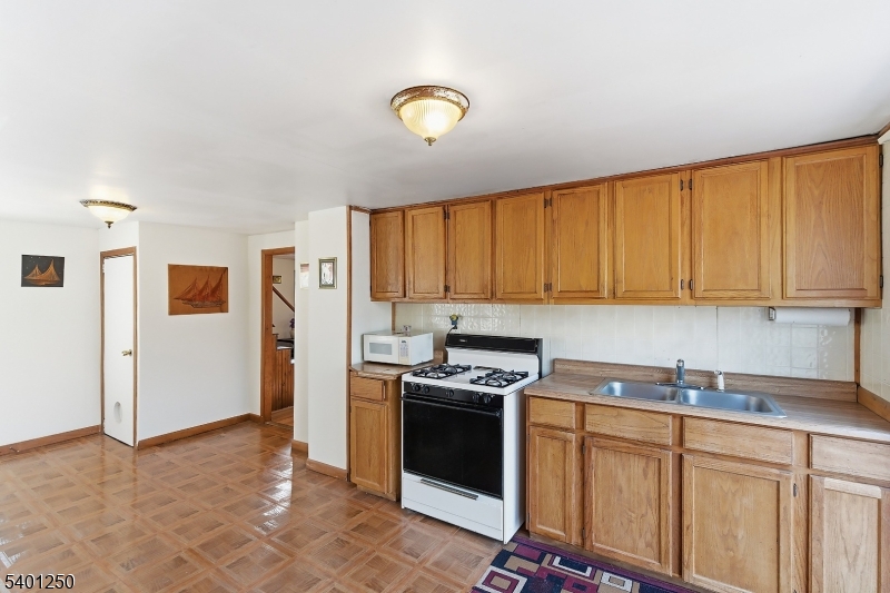 491 Lakehurst Road Browns Mills, NJ 08015 - Photo 9 of 17 a kitchen with stainless steel appliances granite countertop a stove a sink and a refrigerator