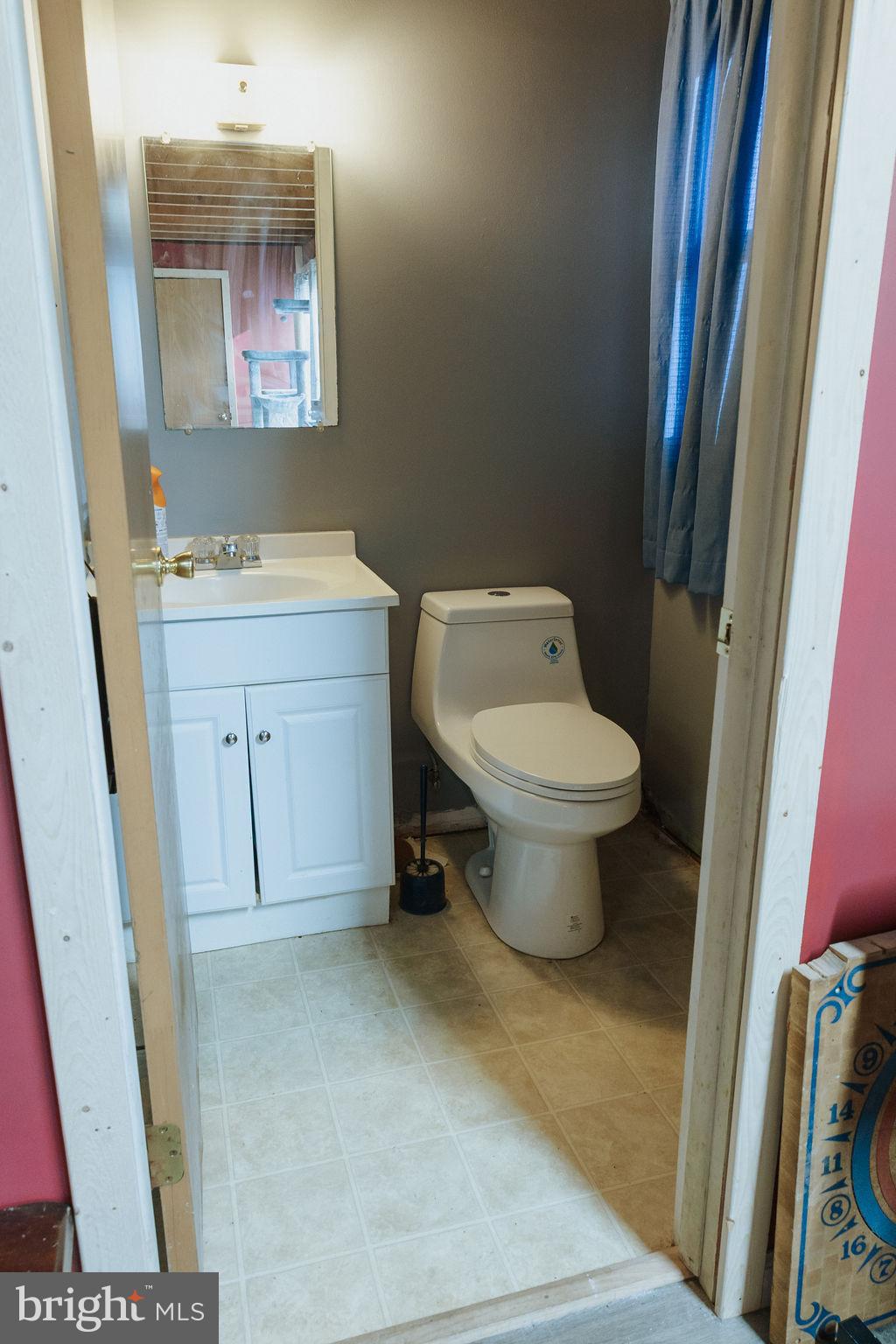 3483 Messersmith Road York, PA 17408 - Photo 16 of 18 a bathroom with a toilet sink and mirror