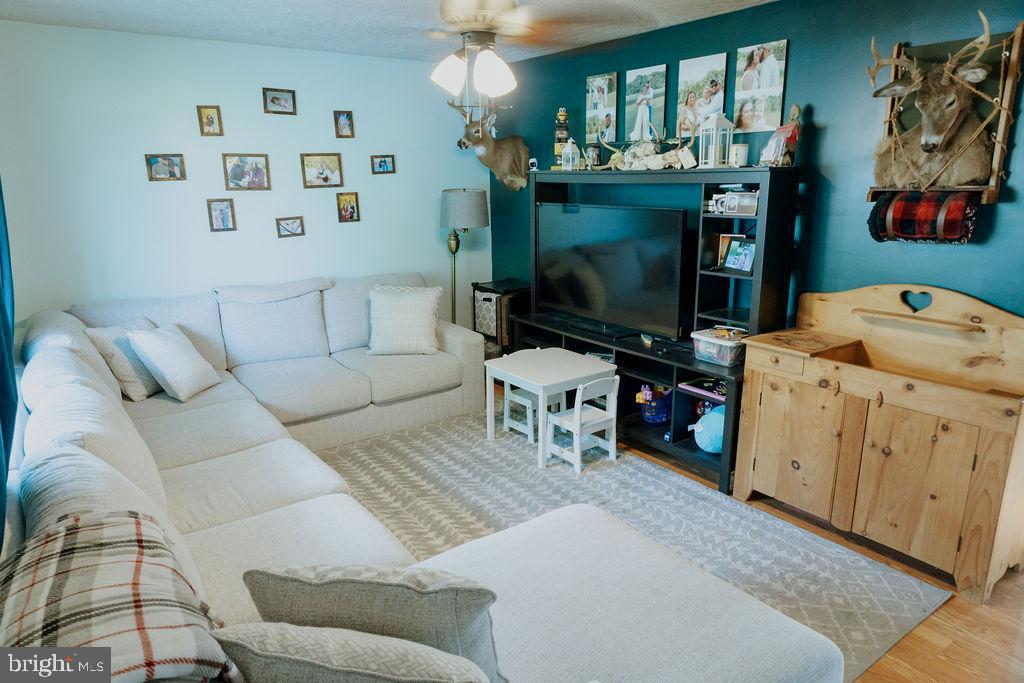 3483 Messersmith Road York, PA 17408 - Photo 2 of 18 a living room with furniture and a flat screen tv