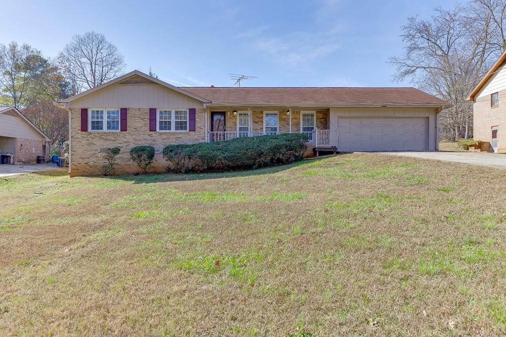 a front view of a house with yard and garage
