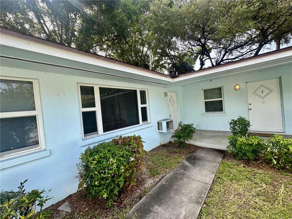 706 19th Street, Unit 3 Vero Beach, FL 32960 - Photo 1 of 9 a front view of a house with garden