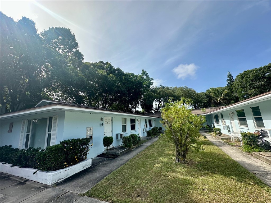 706 19th Street, Unit 3 Vero Beach, FL 32960 - Photo 2 of 9 front view of a house with a yard