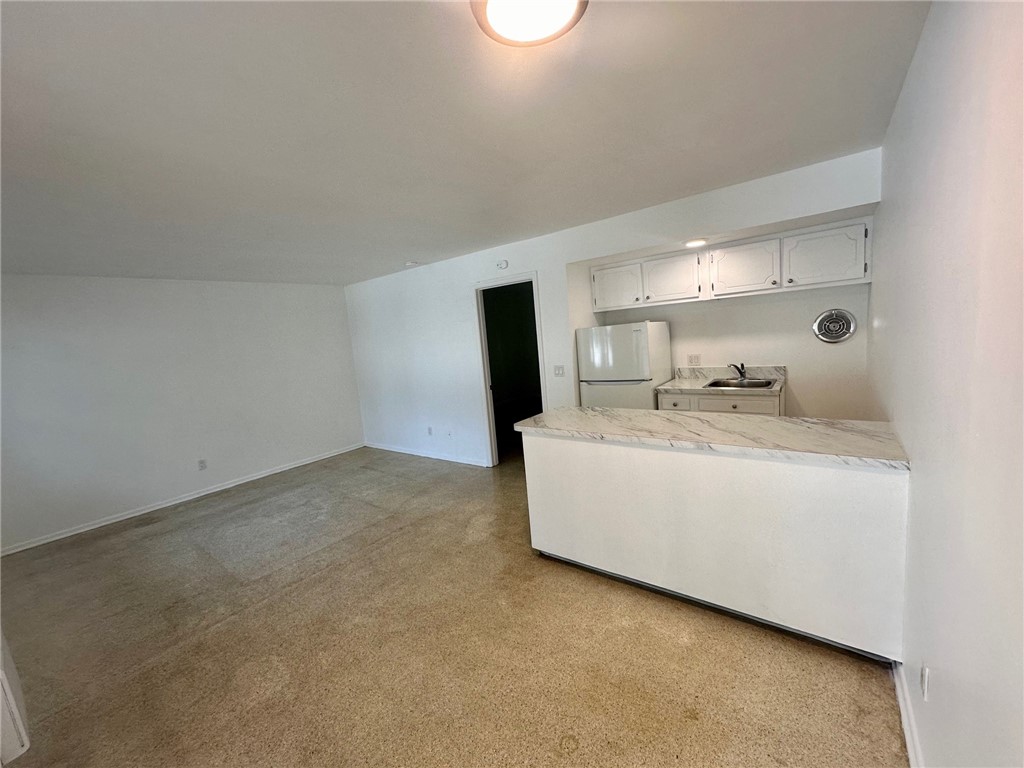 706 19th Street, Unit 3 Vero Beach, FL 32960 - Photo 3 of 9 a room with a bed and a flat tv screen on dresser