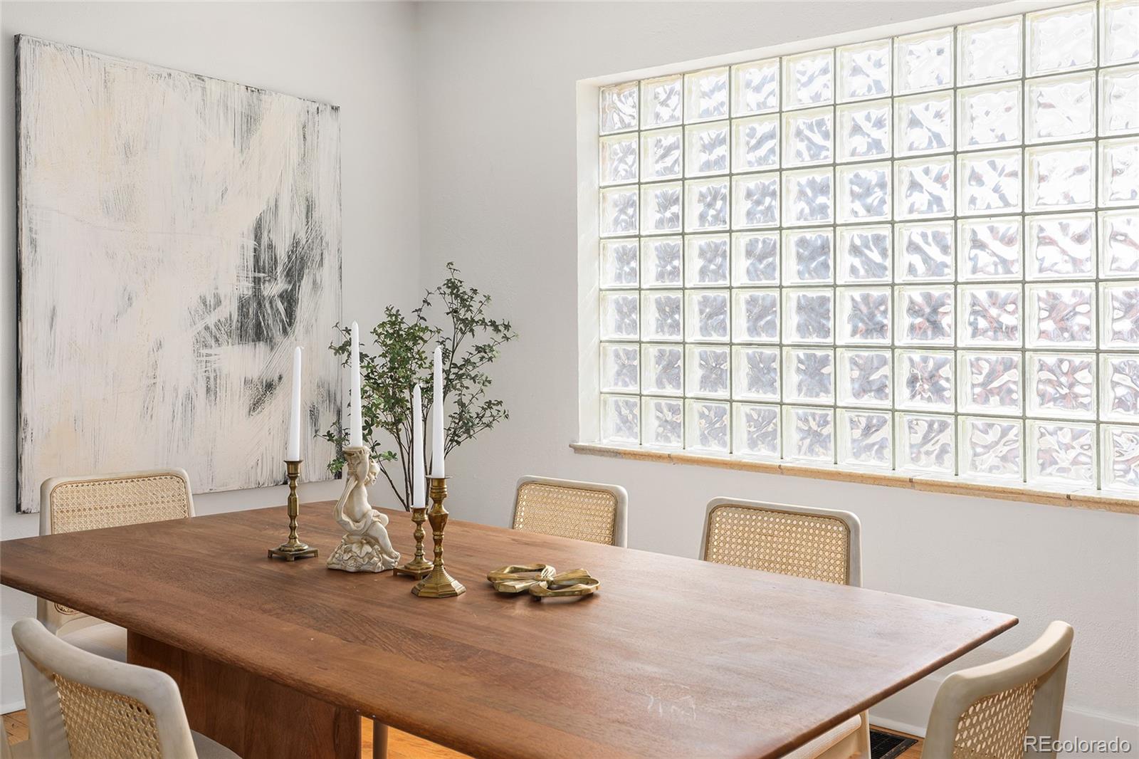 692 South Logan Street Denver, CO 80209 - Photo 12 of 40 a dining room with a table and chairs in it