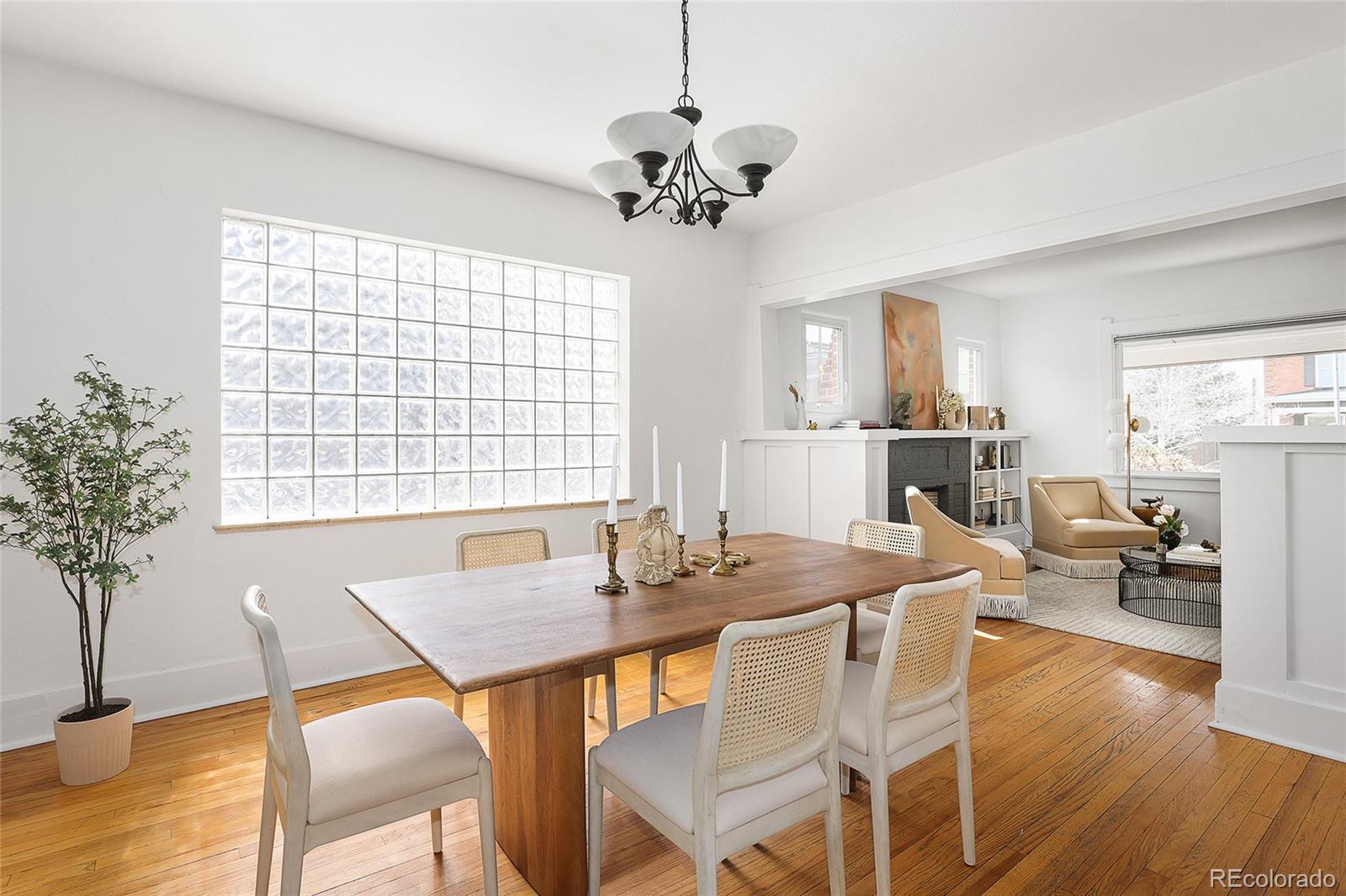 692 South Logan Street Denver, CO 80209 - Photo 14 of 40 a view of a dining room with furniture window and wooden floor