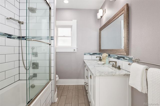 a bathroom with a tub sink and mirror