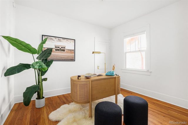 a work room with furniture and potted plant