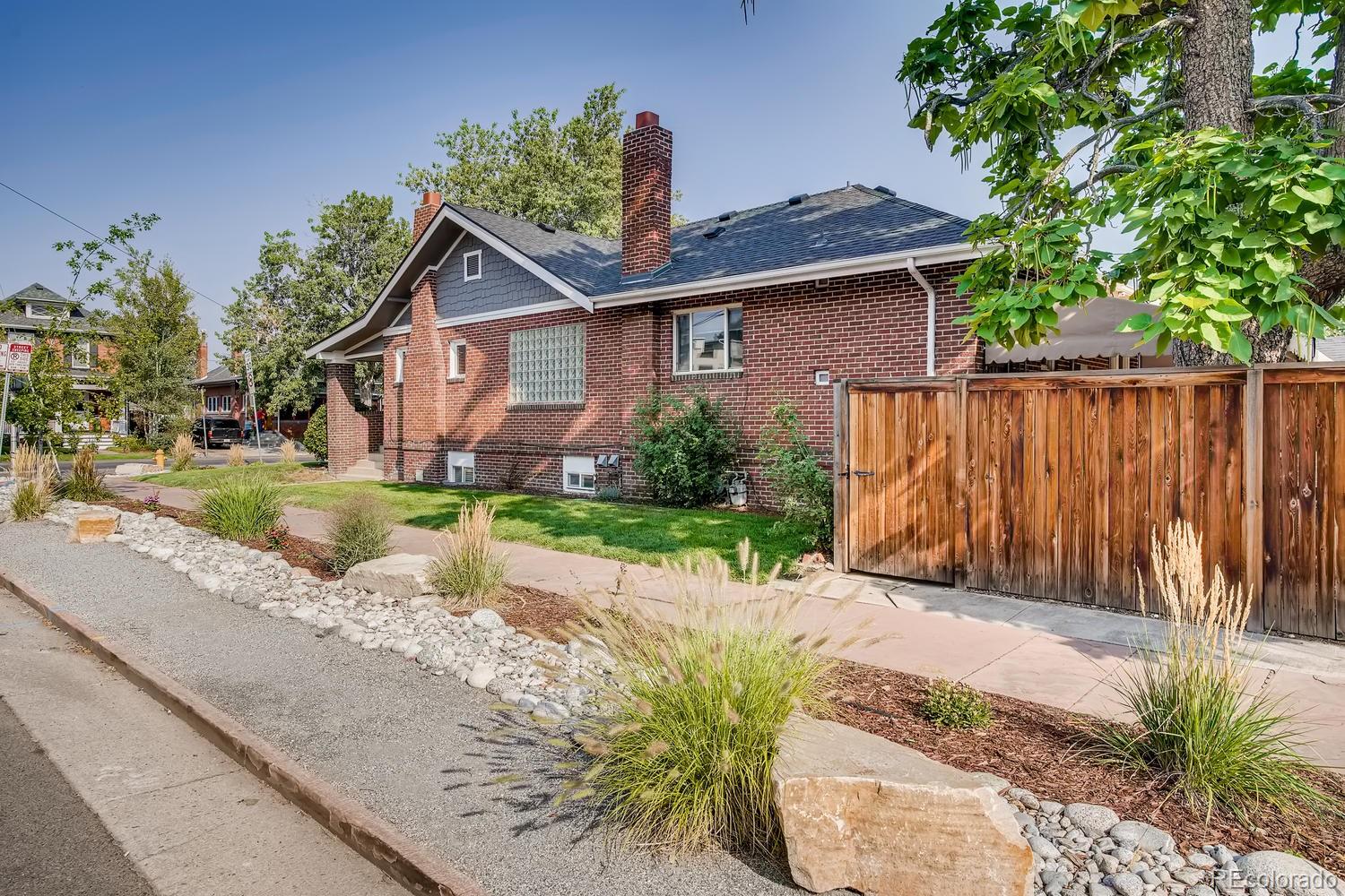 692 South Logan Street Denver, CO 80209 - Photo 2 of 40 a view of a house with a small yard and plants