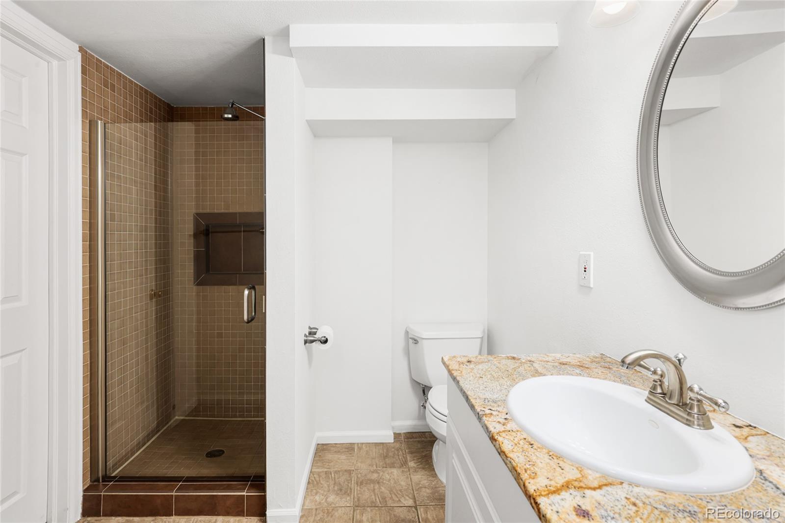 692 South Logan Street Denver, CO 80209 - Photo 21 of 40 a bathroom with a sink a toilet and shower