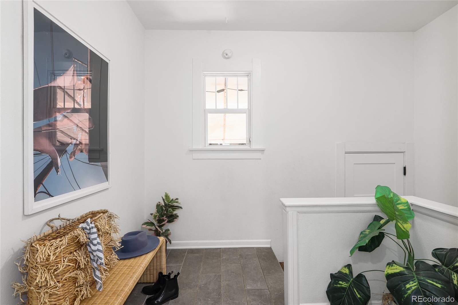 692 South Logan Street Denver, CO 80209 - Photo 22 of 40 a living room with furniture and a potted plant
