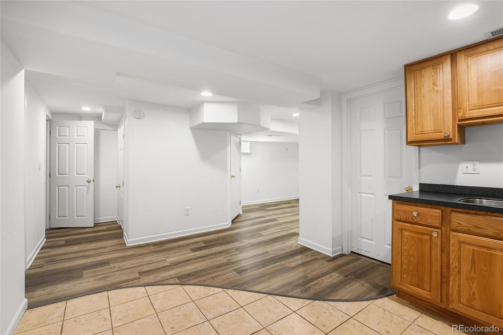 692 South Logan Street Denver, CO 80209 - Photo 23 of 40 a view of a kitchen with wooden floor and a sink