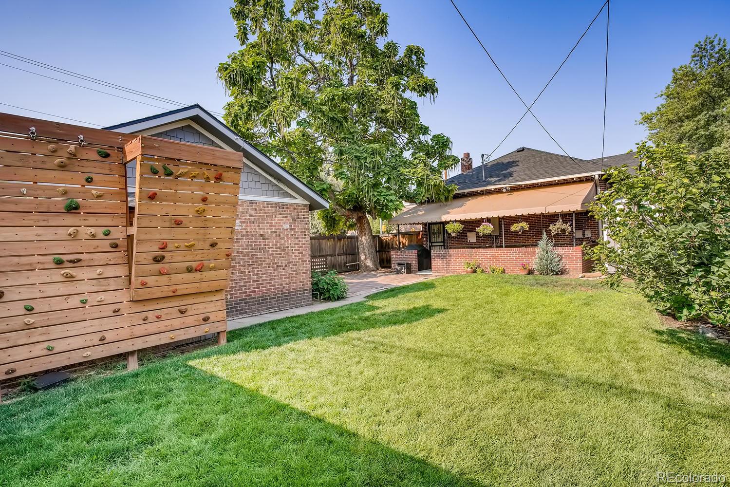 692 South Logan Street Denver, CO 80209 - Photo 30 of 40 a view of a house with a yard
