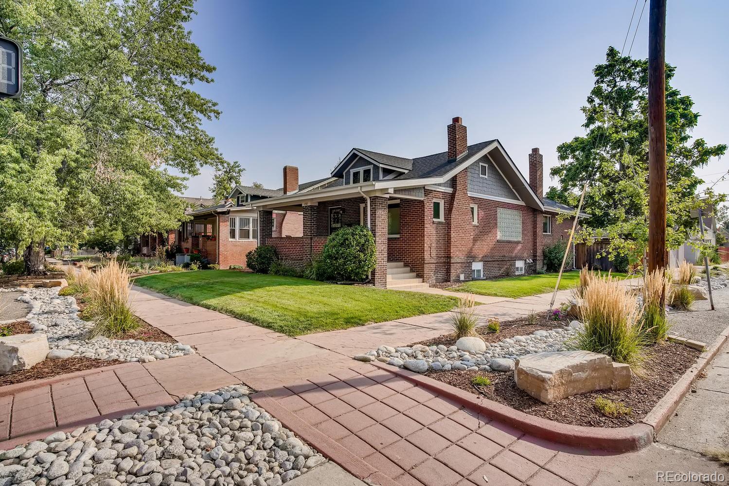 692 South Logan Street Denver, CO 80209 - Photo 3 of 40 a front view of a house with garden