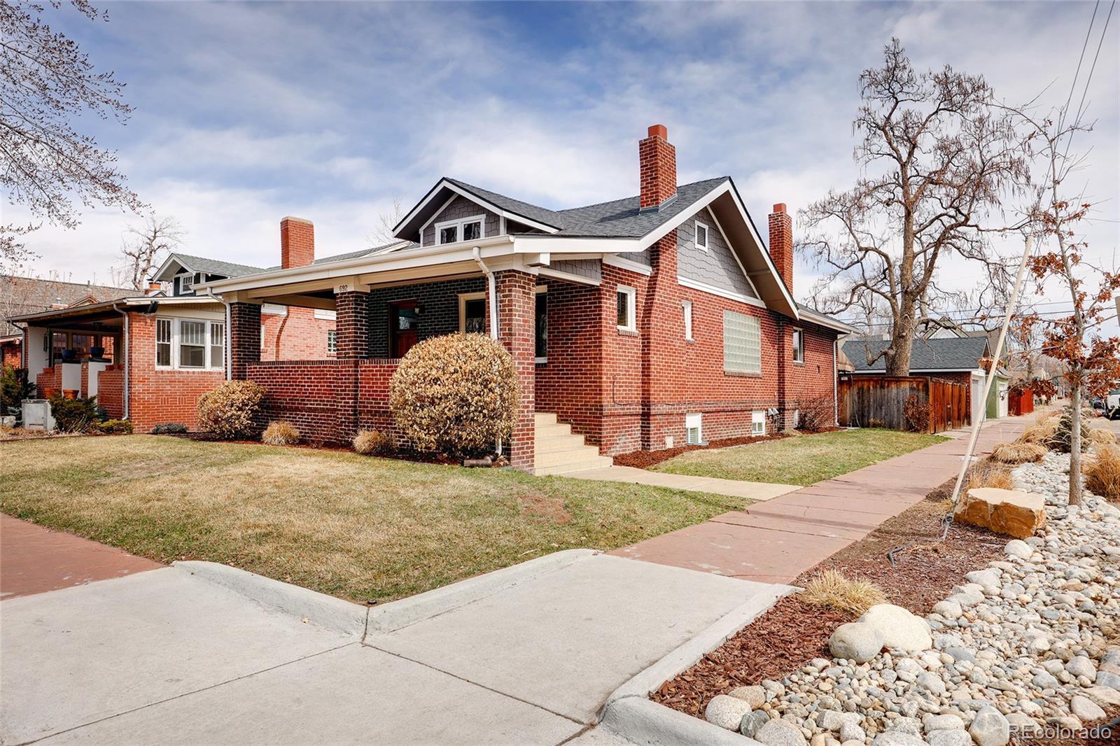 692 South Logan Street Denver, CO 80209 - Photo 39 of 40 a front view of a house with a yard and garage