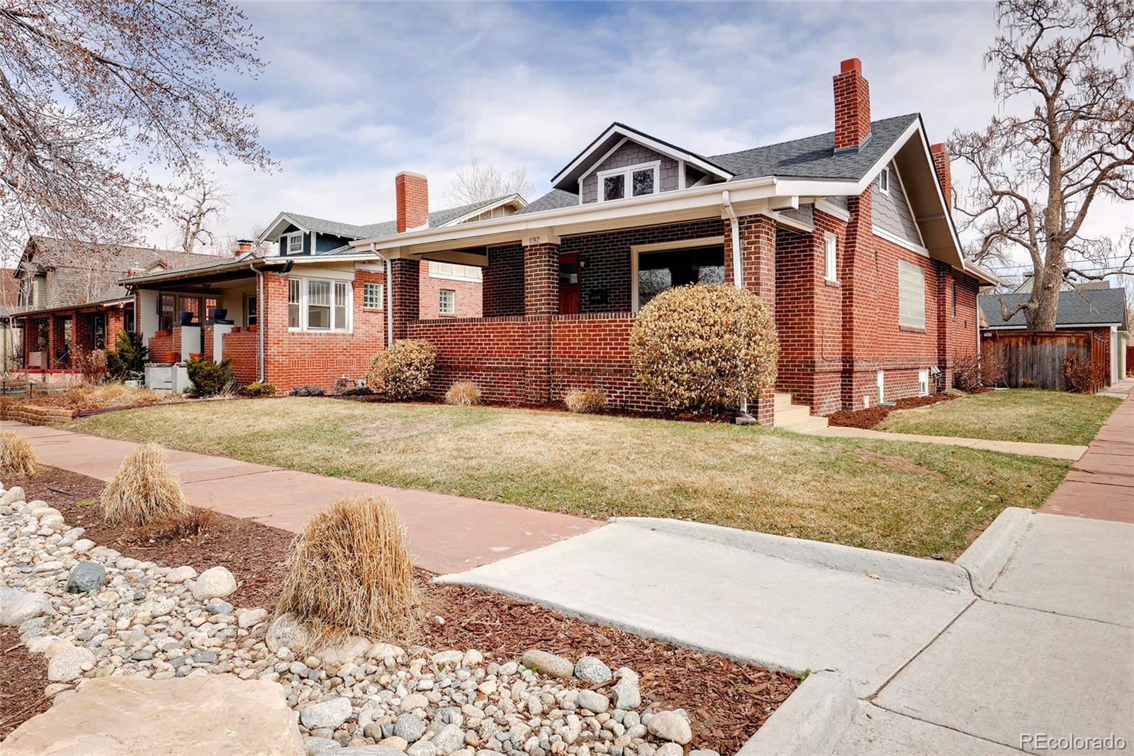 692 South Logan Street Denver, CO 80209 - Photo 40 of 40 a front view of a house with a yard