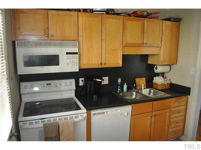 2361 Bernard Street Raleigh, NC 27608 - Photo 5 of 11 a kitchen with stainless steel appliances granite countertop a stove a sink and a microwave